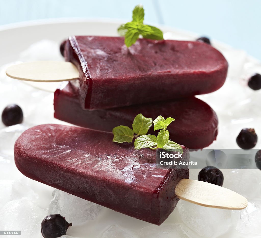 Three dark red ice pops with garnish Homemade currant ice cream pops Backgrounds Stock Photo