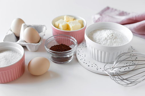 ingredients for baking chocolate cake on white table