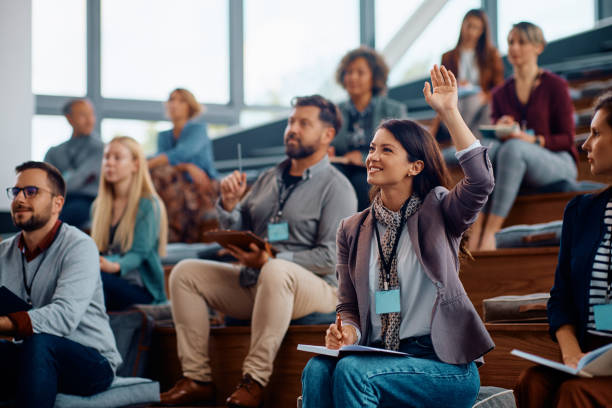 istock Female entrepreneur raising a hand to ask a question while attending business seminar. 1783738745