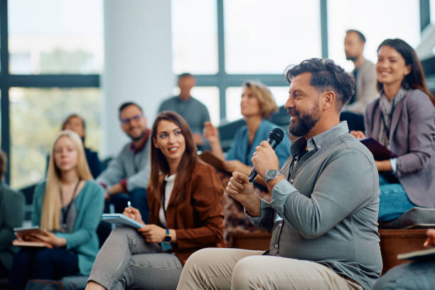 istock Male entrepreneur asking a question while attending business seminar in conference hall. 1783738756