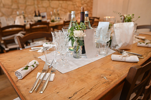Beautiful Boho Wedding Table Decoration with olive branches and rose drink glasses in Majorca. Selective focus