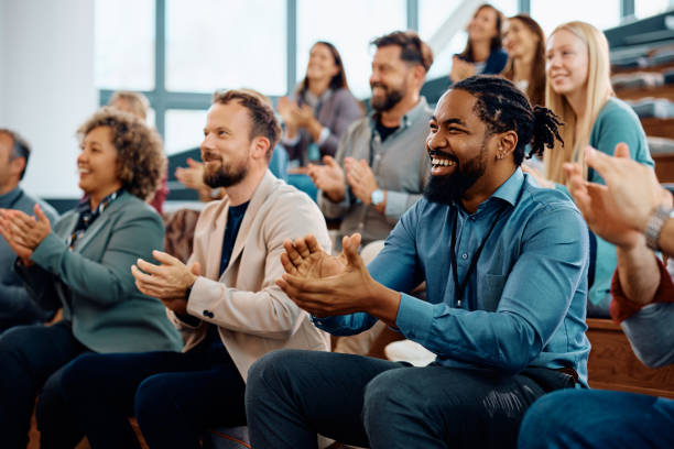 istock Happy black entrepreneur applauding while attending business seminar at conference hall. 1783742492