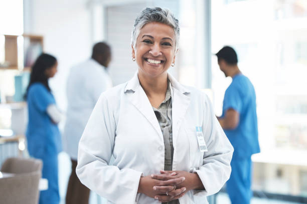 Senior doctor, woman and smile in clinic portrait for inspection, excited and vision for expert. Female medic, leadership and management with confidence, success and happy for career goal at hospital Senior doctor, woman and smile in clinic portrait for inspection, excited and vision for expert. Female medic, leadership and management with confidence, success and happy for career goal at hospital happiness four people cheerful senior adult stock pictures, royalty-free photos & images