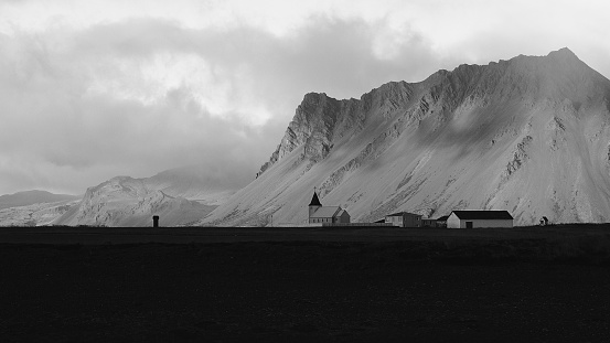 Black and white church in icelandic landscape