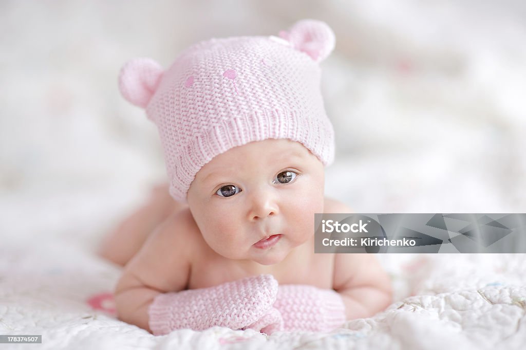 newborn baby girl in pink knitted bear hat Baby Girls Stock Photo