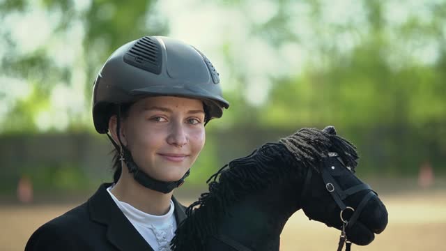 girl looks into the camera.equestrian sport.