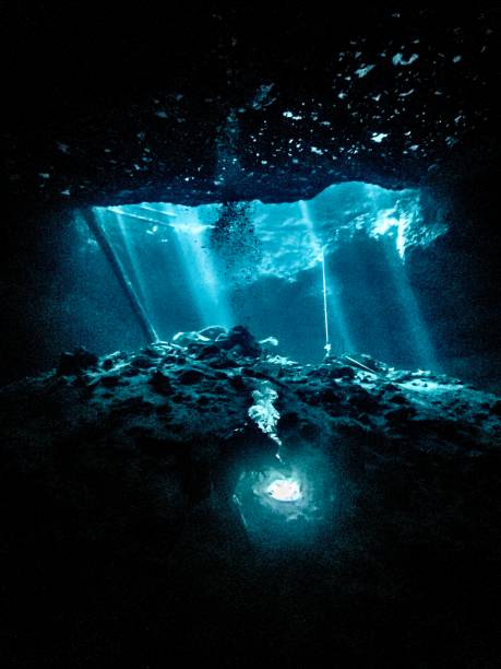 istock A single diver is backlight in the entrance to an underwater cavern in Florida 1783751294