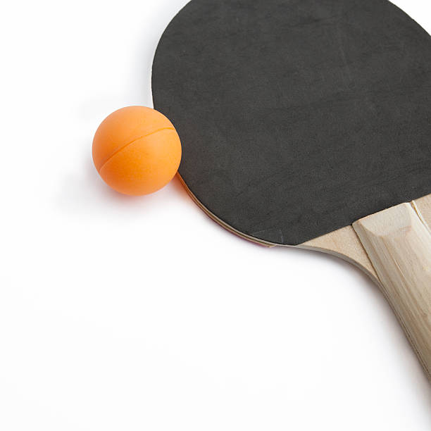 Ping pong paddle with orange ball stock photo