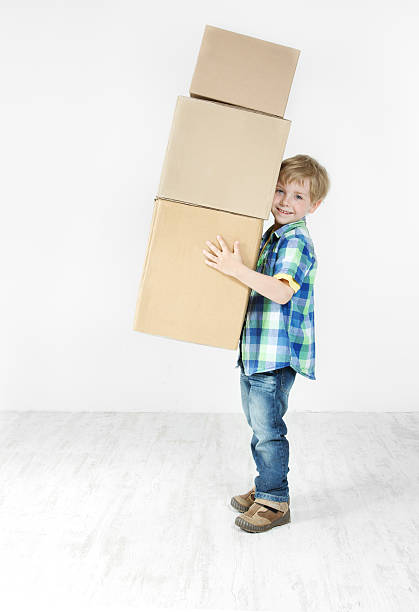 istock Boy holding pyramid of carton boxes 178375277