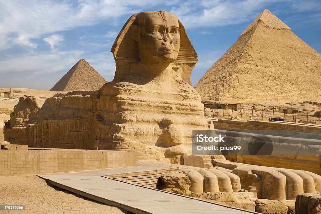 Full Sphynx Profile Pyramid Giza Egypt A beautiful profile of the Great Sphinx including the pyramids of Menkaure and Khafre in the background in Giza, Cairo, Egypt The Sphinx Stock Photo