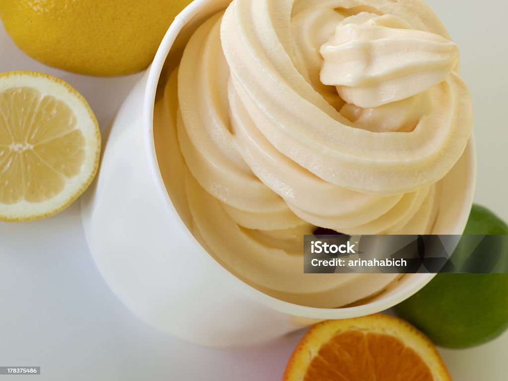 Frozen Soft Serve Yogurt Cup of tropical frozen yogurt with fresh fruit. Soft Serve Ice Cream Stock Photo