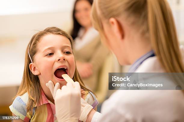Pediatrician Examining A Little Girls Throat Stock Photo - Download Image Now - Girls, Doctor, Examining