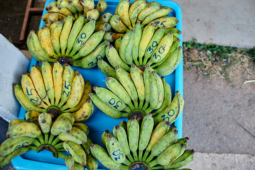 Bunch of fresh bananas at market stall