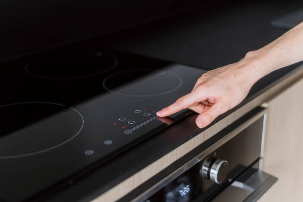 istock Female hand press button on digital control panel of electric cooker hob 1783757755