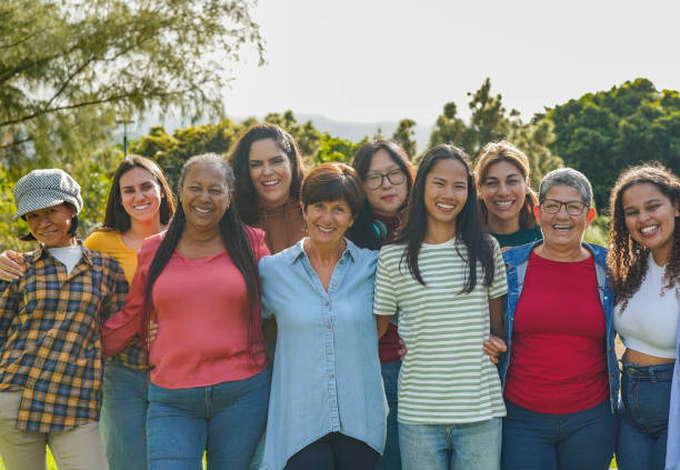 istock Group of multi generational women hugging each other while smiling on camera at city park - Multiracial female friends and community concept 1783762790