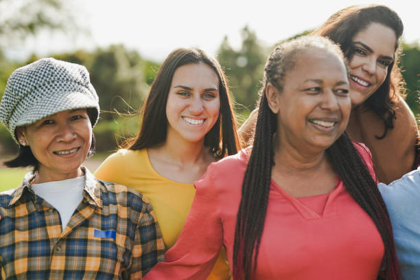 istock Group of multiracial women with different ages smiling in front of camera while hugging each other at city park - Female community and multi generational concept 1783763348