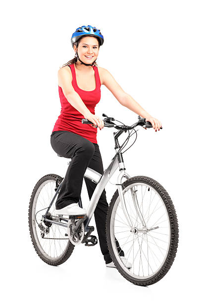 beautiful woman riding a bicycle with winning attitude, studio shot.