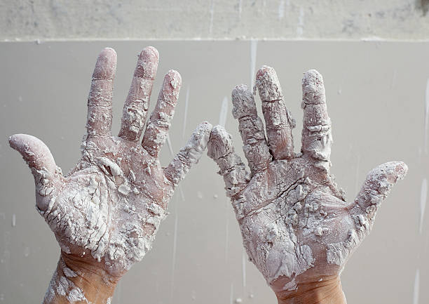 istock Astist plastering man hands with cracked plaster 178376828