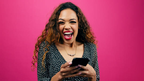 istock Shocked young woman gets successful match on dating profile, studio pink 1783770208