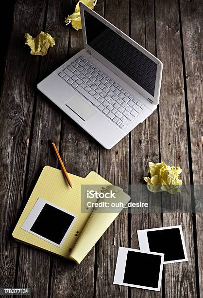 Laptop Instant Photos And Crumpled Paper On Table Stock Photo - Download Image Now