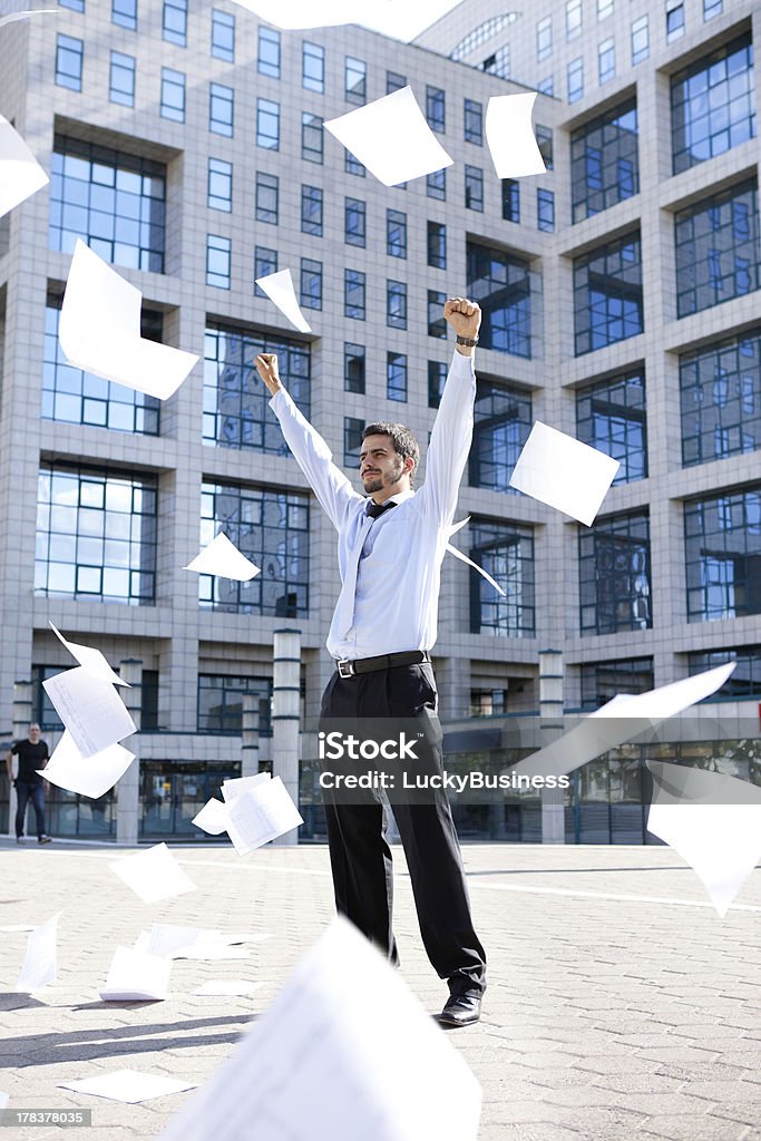 young businessman throwing away his papers "young businessman standing front his building office and throwing away his papers, Never felt so good" Flying Stock Photo