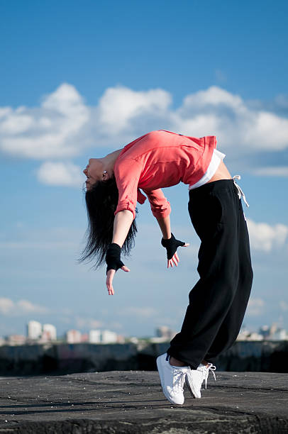 istock woman dancing hip hop over blue sky 178378215