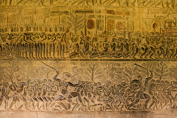 The wall of one of the galleries of Angkor Wat with its linear arrangement of stone carving, adorned with bas-reliefs showing large-scale narrative scenes mainly depicting episodes from the Hindu epics the Ramayana and the Mahabharata
