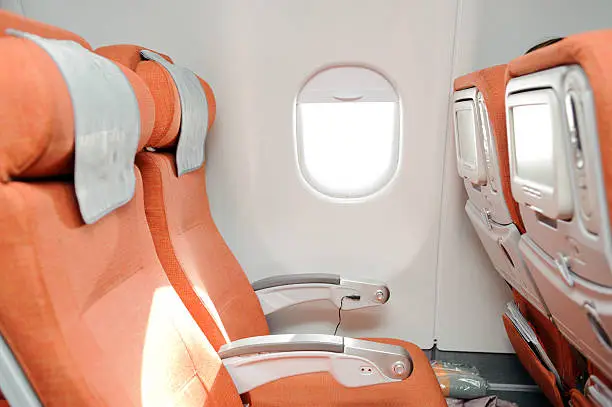 orange seats in airplane cabin of airbus 330