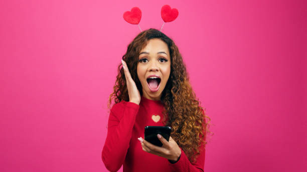 istock Shocked young woman gets successful match on dating profile, studio hearts 1783787995