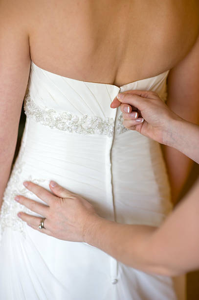 istock zipping up the wedding dress 178379313