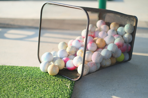 Close-up shot Large Group of Golf Balls Inside Metal Bucket at the Driving Range
