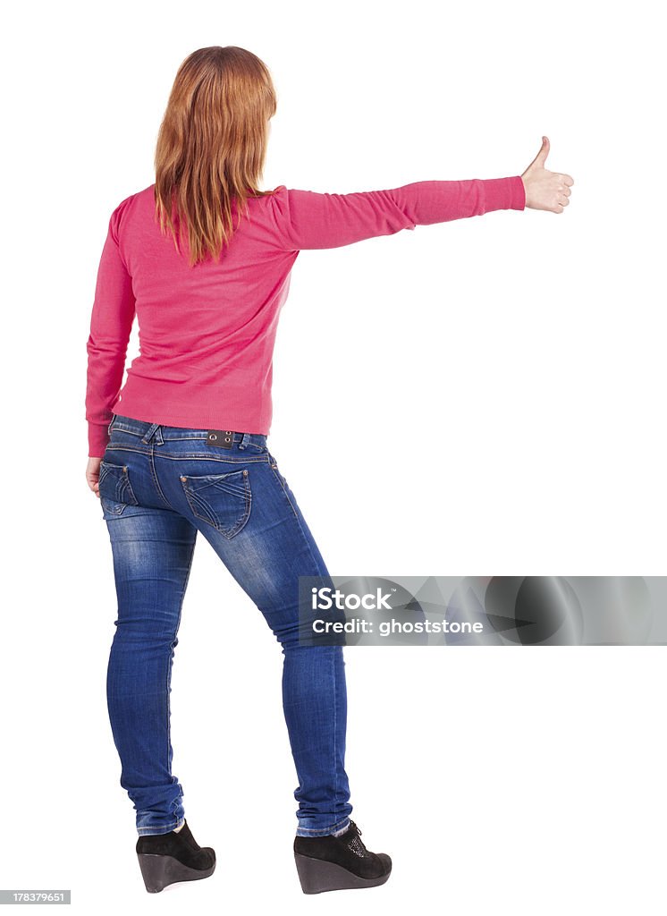 Vista posterior de joven hermosa mujer pulgar hacia arriba. - Foto de stock de Adulto libre de derechos