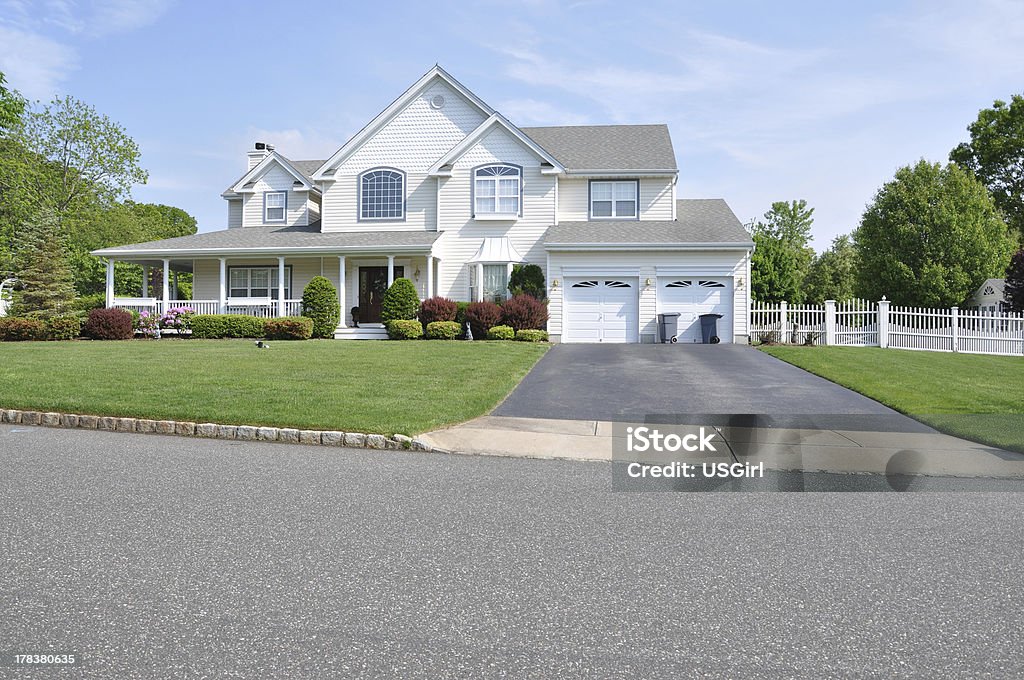 Trash Cans Suburban Home Driveway Two story double car garage with trash can containers landscaped front yard beautiful large suburban home House Stock Photo