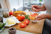Close up of woman hands preparing Spanish tomato toast
