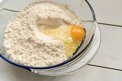 Flour and eggs in a bowl. Homemade cake.