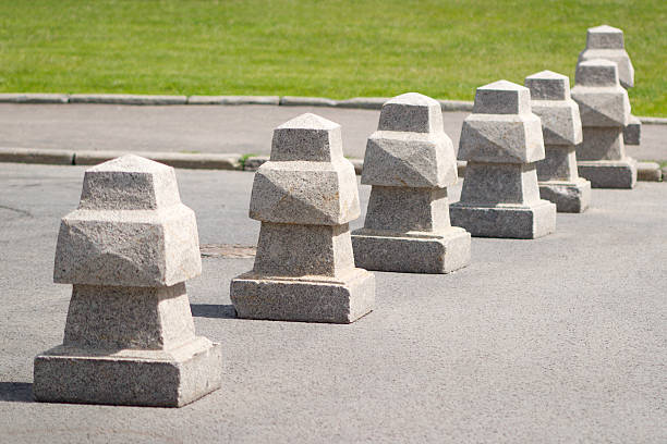 istock Barrier of seven stone pillar blocks on a road 178380986