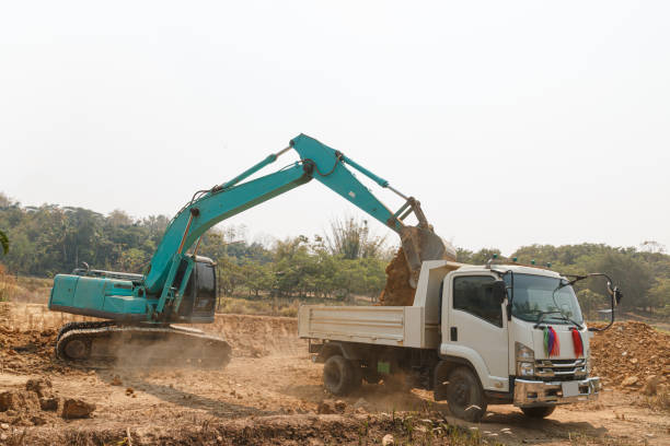 istock Excavator digging the soil into a truck 1783811059