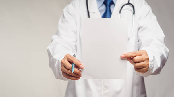 istock Doctor holding a blank white paper while standing in the hospital 1783812211
