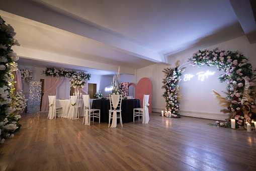 Elegant showroom with flower arch and accessories.