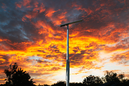 Solar cell street lamp pole on oranges  sky \n background of  sunset