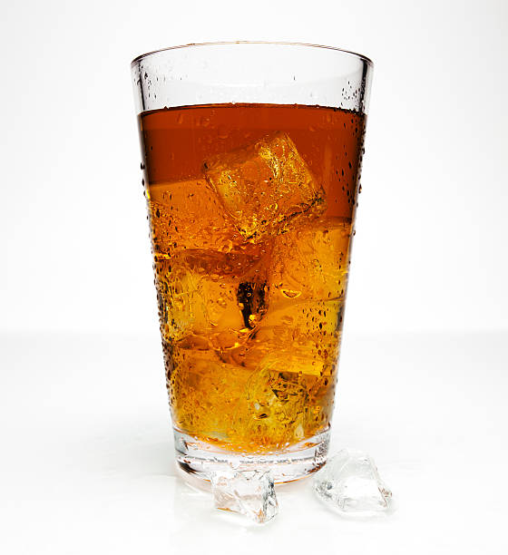 Big glass of iced tea with two ice cubes at base of glass