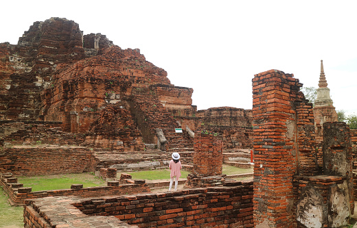 Female Traveler Being Impressed with the Massive Temple Ruins of Wat Mahathat in the Ayutthaya Historical Park, Ayutthaya, Thailand, ( Self Portrait )