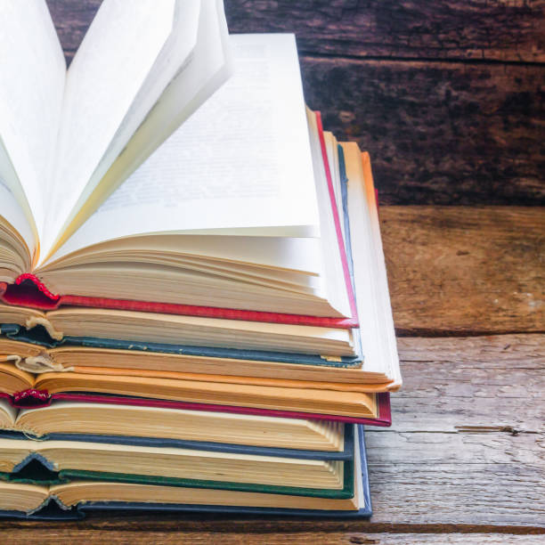 istock vintage opened books on a wooden background and space for text 1783820189