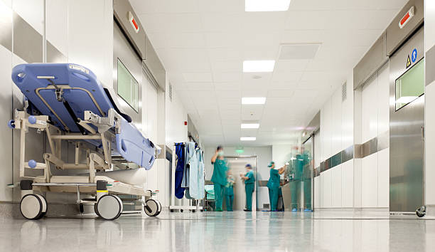 Hospital surgery corridor Blurred figures of people with medical uniforms in hospital corridor hospital room stock pictures, royalty-free photos & images