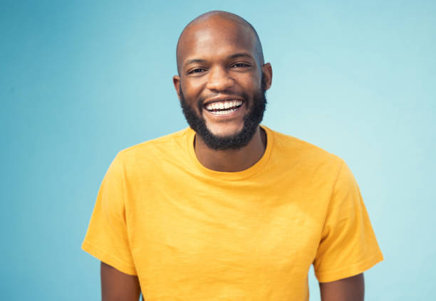 istock Black man, portrait or laughing on blue background, isolated mockup or wall mock up at comic, funny or comedy joke. Smile, happy face or student in trendy, cool or stylish fashion clothes on backdrop 1783824350