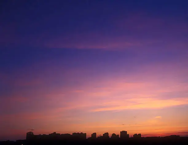 Beautiful multicolored sunset over a dark cityscape. You can find my other similar photos here