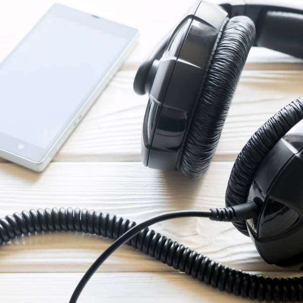 istock headphones and mobile phone on a white background 1783826089