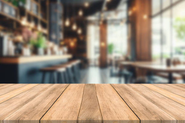 istock Empty wooden table space platform and blurred restaurant or coffee shop background for product display montage 1783826618