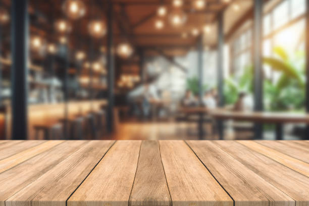 istock Empty wooden table space platform and blurred restaurant or coffee shop background for product display montage 1783826619