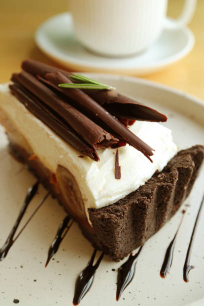 istock Delectable Banoffee Pie with Blurry Cup of Hot Drink in the Background 1783830696
